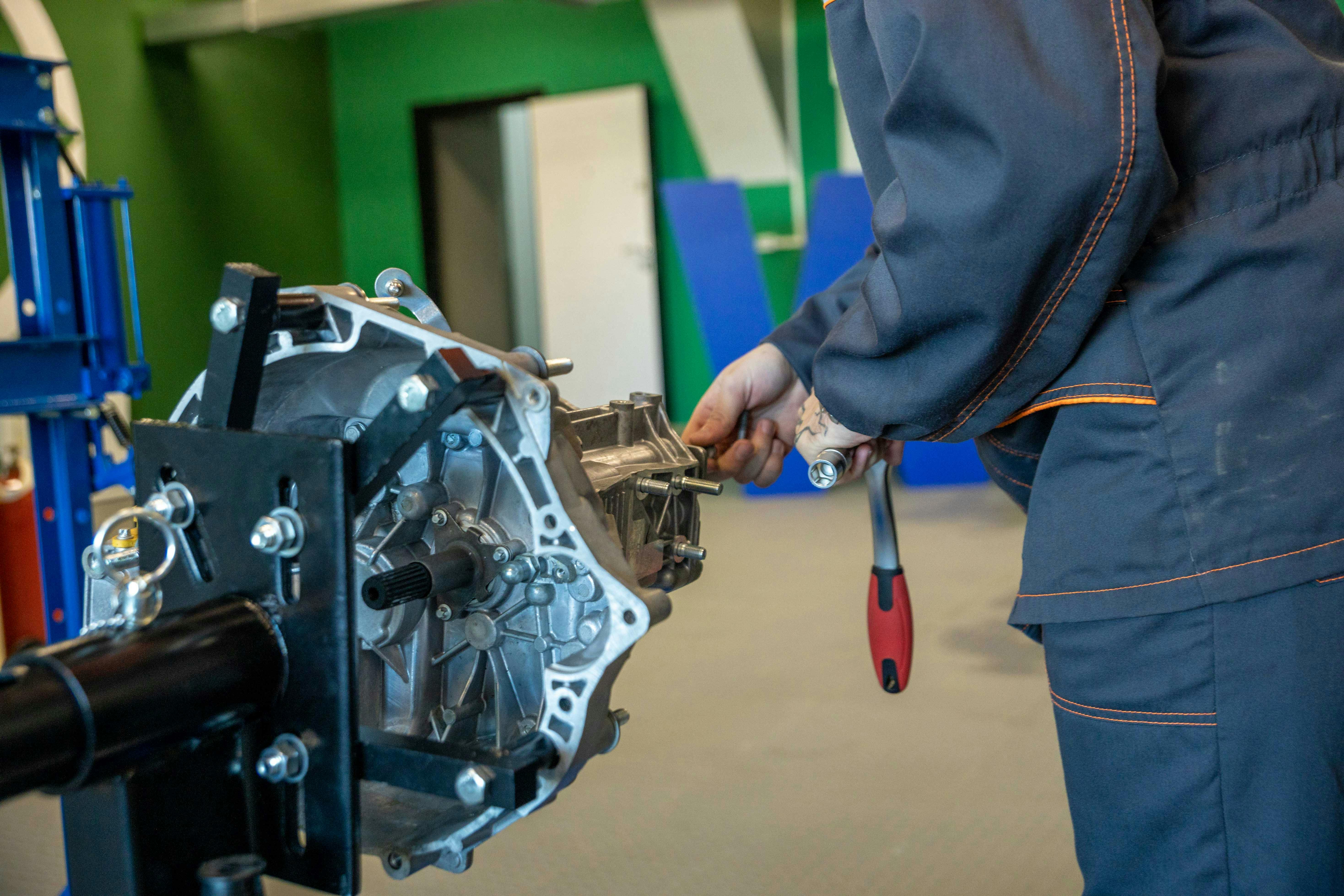 Mechanic working on a vehicle transmission at RCore Transmissions in Oklahoma City